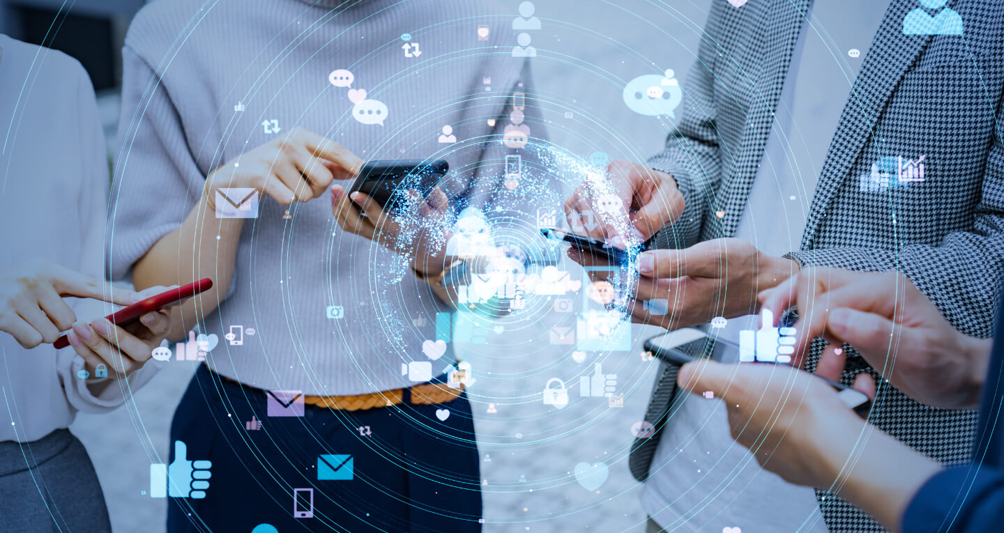 Four people checking their communications dashboard to send automated SMS
