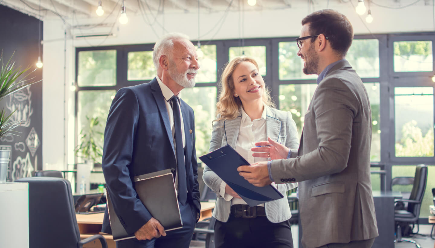 Three people discussing their next automated communications campaign