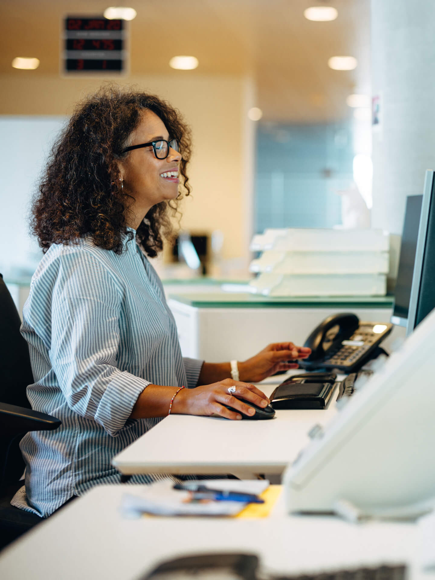 A happy woman automating her businesses communication channels with WelCorp