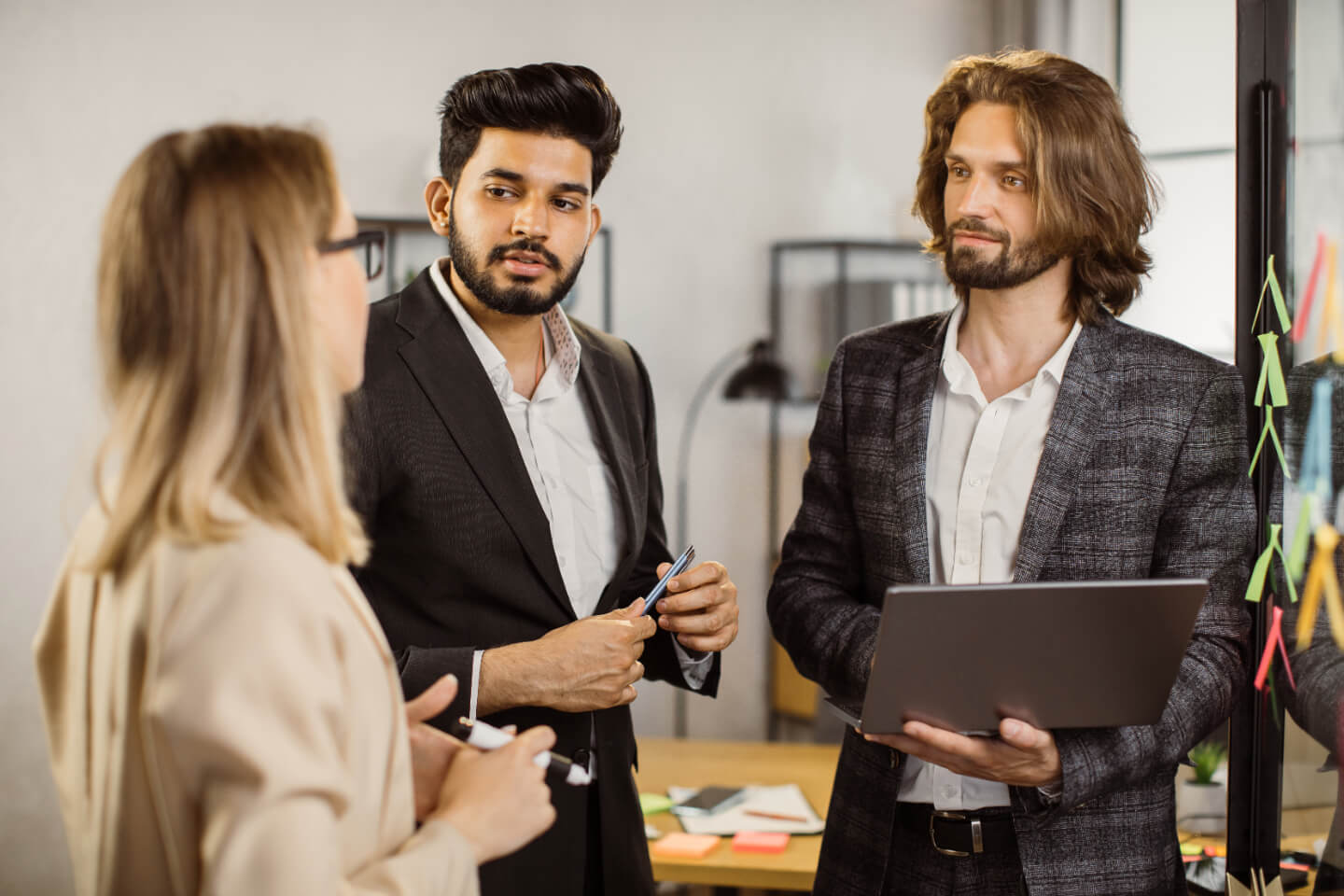Three people discussing API options for their communication solutions